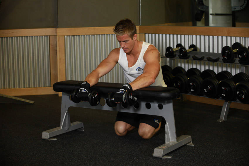 Palms-Down Dumbbell Wrist Curl Over A Bench